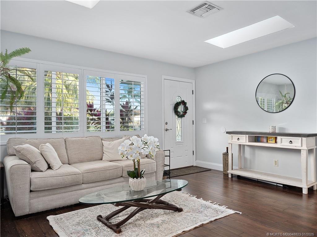 1544 Northwest Spruce Ridge Drive Stuart, FL 34994 - Photo 5 of 23 a living room with furniture and wooden floor