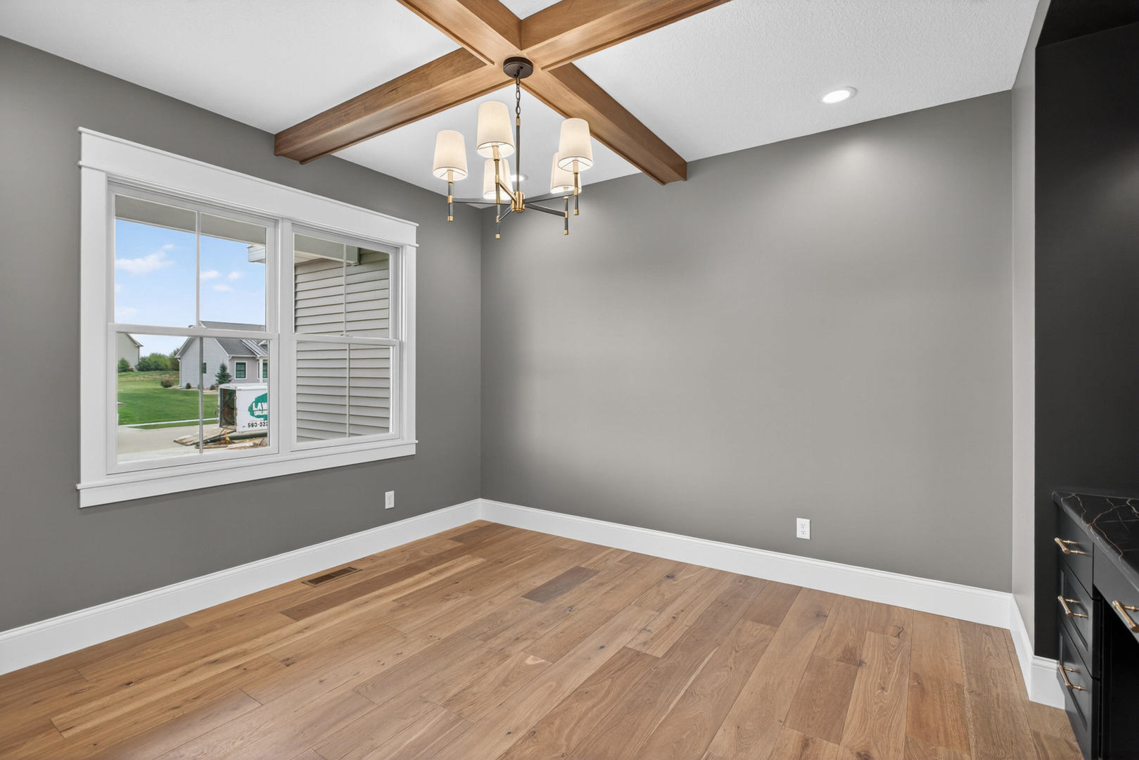 6928 Wilderness Pointe Bettendorf, IA 52722 - Photo 7 of 48 en empty room with wooden floor and windows