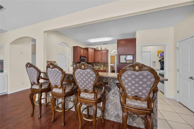 a dining room with furniture and wooden floor