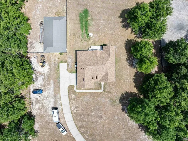 an aerial view of a house with outdoor space and parking