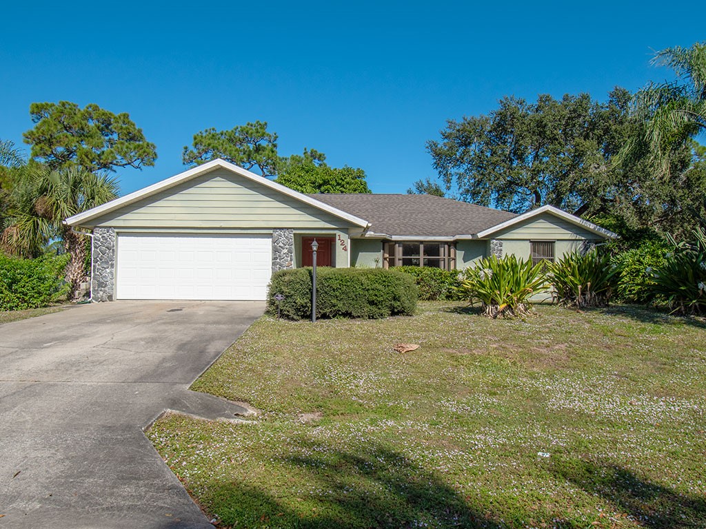 124 Hinchman Avenue Sebastian, FL 32958 - Photo 1 of 31 a front view of a house with a yard