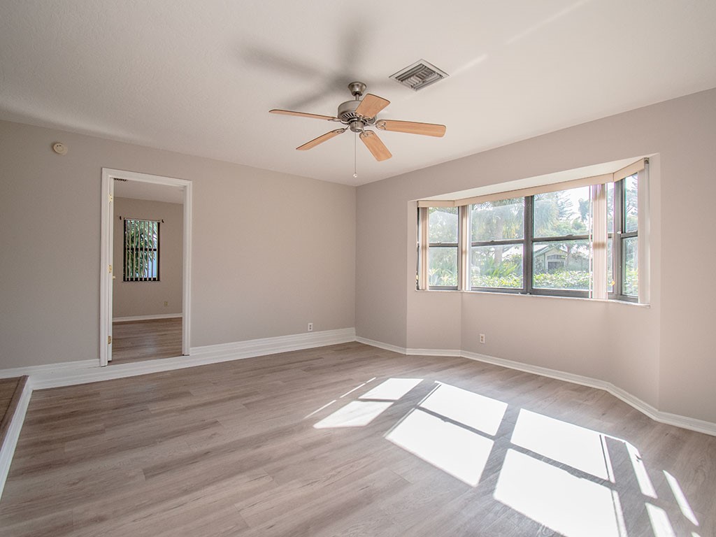 124 Hinchman Avenue Sebastian, FL 32958 - Photo 15 of 31 a view of empty room with wooden floor and fan