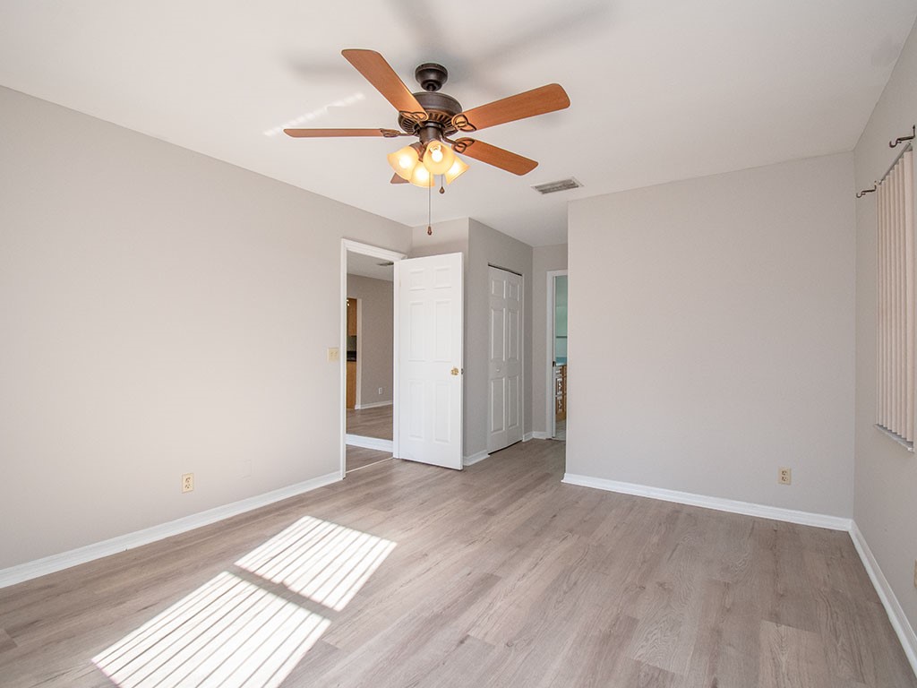 124 Hinchman Avenue Sebastian, FL 32958 - Photo 21 of 31 a view of an empty room with window and wooden floor