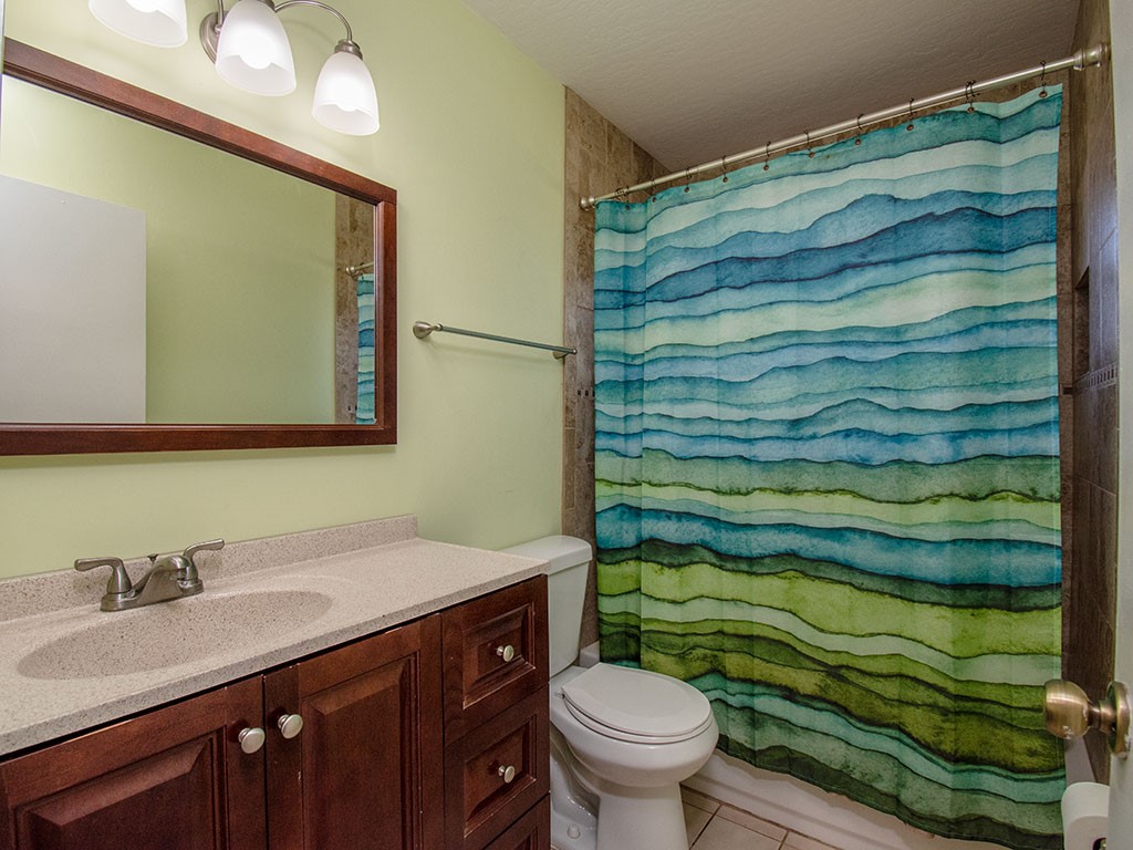 124 Hinchman Avenue Sebastian, FL 32958 - Photo 26 of 31 a bathroom with a sink and a mirror