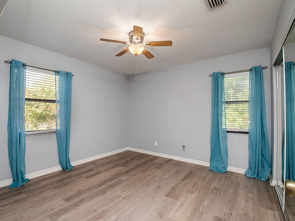 124 Hinchman Avenue Sebastian, FL 32958 - Photo 27 of 31 wooden floor in an empty room with a window