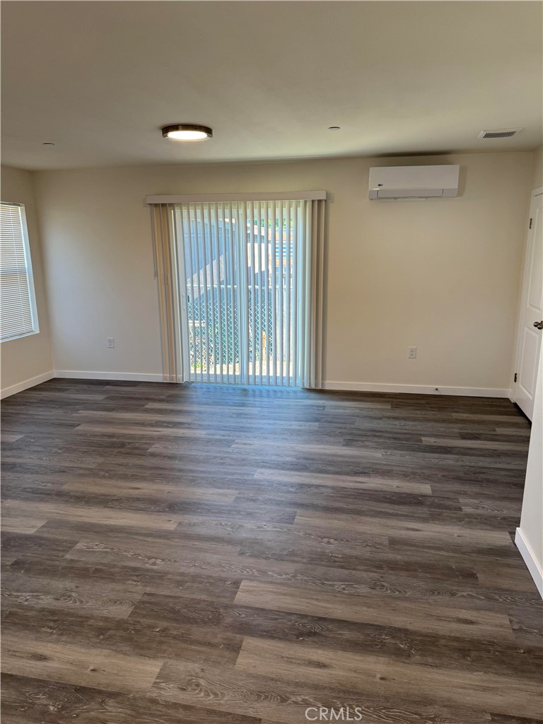 1702 Kippy Drive Colton, CA 92324 - Photo 13 of 24 a view of an empty room with wooden floor and a window