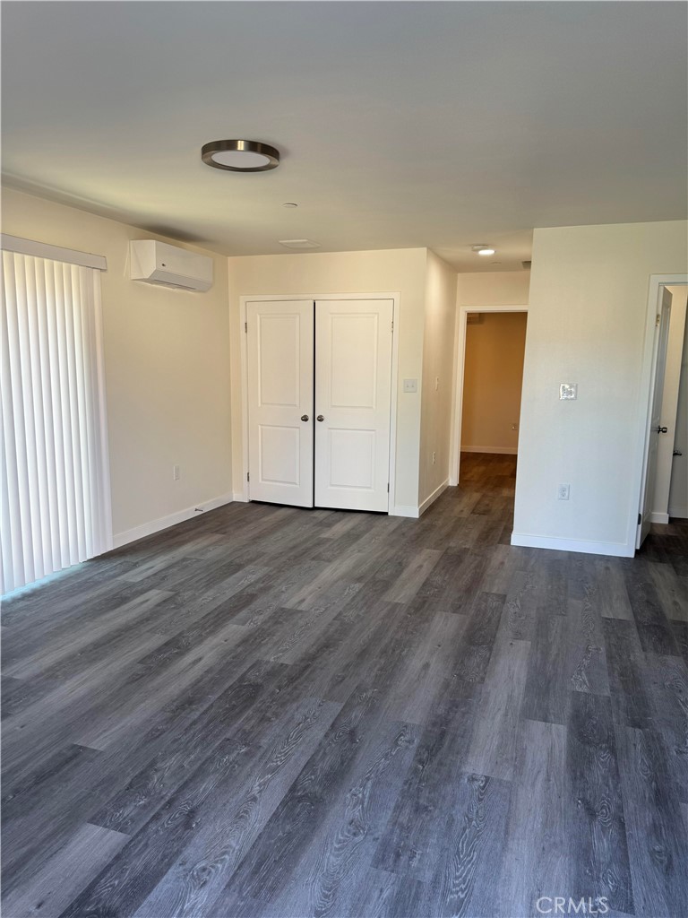 1702 Kippy Drive Colton, CA 92324 - Photo 14 of 24 an empty room with wooden floor and windows