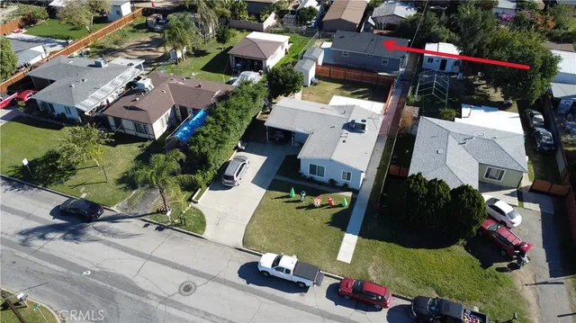 an aerial view of multiple houses with yard