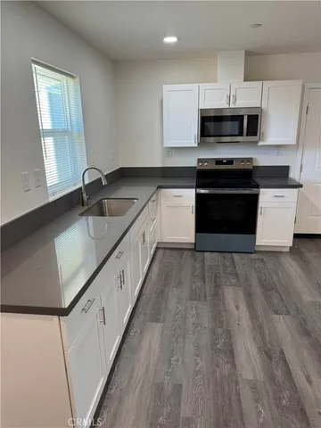 a large kitchen with a stove and a sink