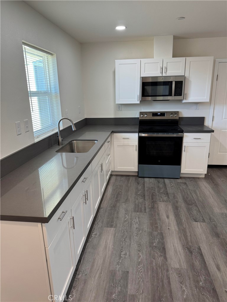 1702 Kippy Drive Colton, CA 92324 - Photo 10 of 24 a large kitchen with a stove and a sink