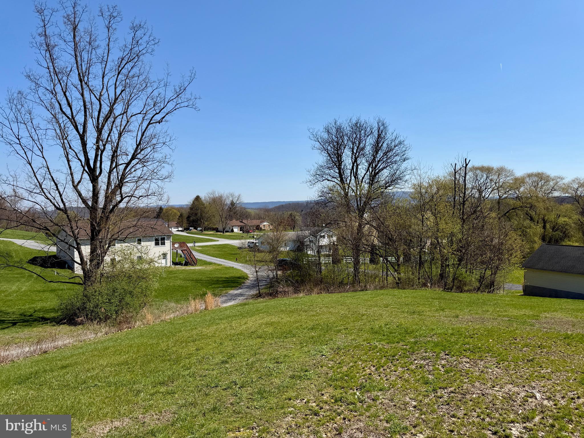 Lot 67 Ridgewood Drive New Paris, PA 15554 - Photo 2 of 9 a view of a garden with trees