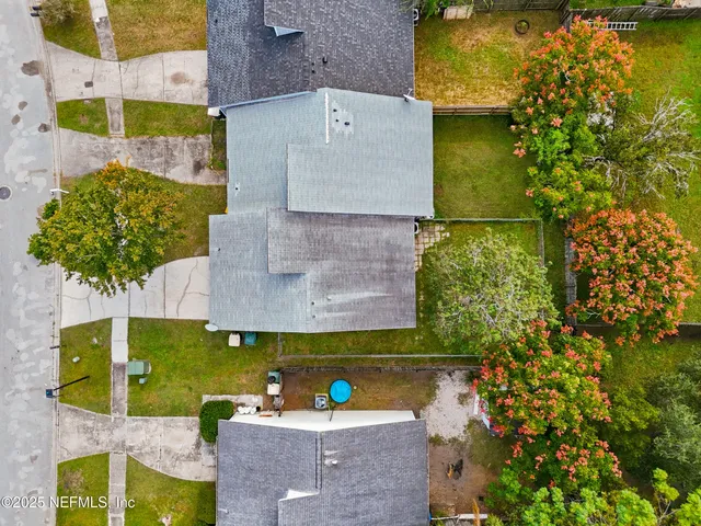an aerial view of a house with a yard basket ball court and outdoor seating
