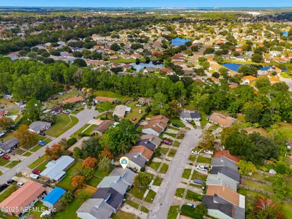 an aerial view of residential building with parking