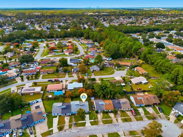 an aerial view of residential houses with outdoor space
