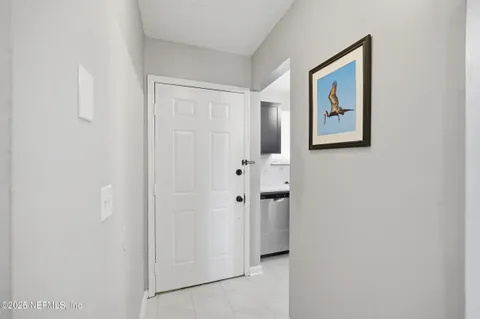 a view of a hallway with white wall
