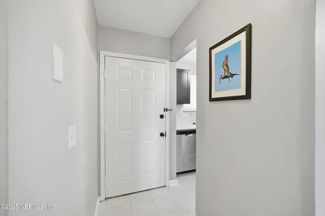 a view of a hallway with white wall