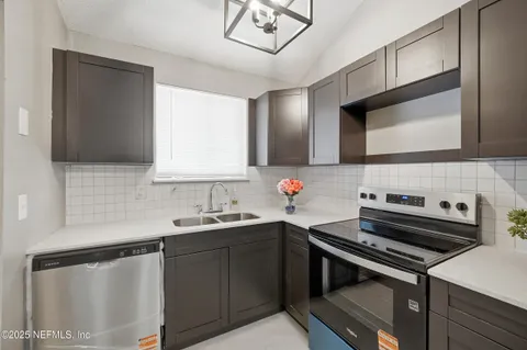 a kitchen with a sink stove and cabinets