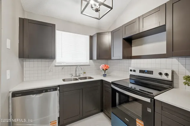 a kitchen with a sink stove and cabinets