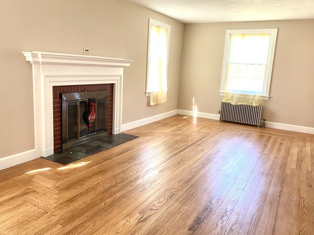 271 Gillette Avenue Springfield, MA 01118 - Photo 15 of 33 a view of an empty room with wooden floor fireplace and a window