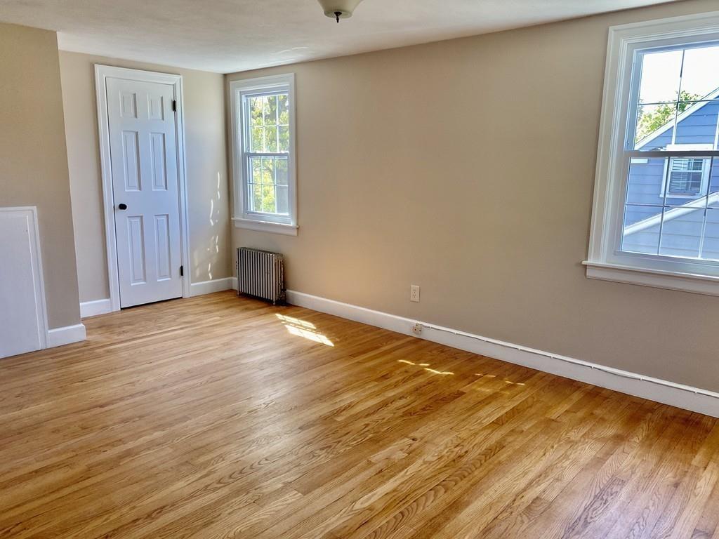 271 Gillette Avenue Springfield, MA 01118 - Photo 28 of 33 an empty room with wooden floor and windows