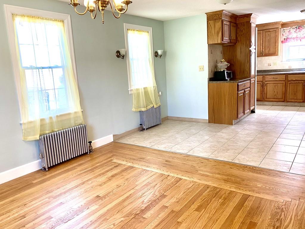 271 Gillette Avenue Springfield, MA 01118 - Photo 9 of 33 a view of a bedroom with wooden floor and windows