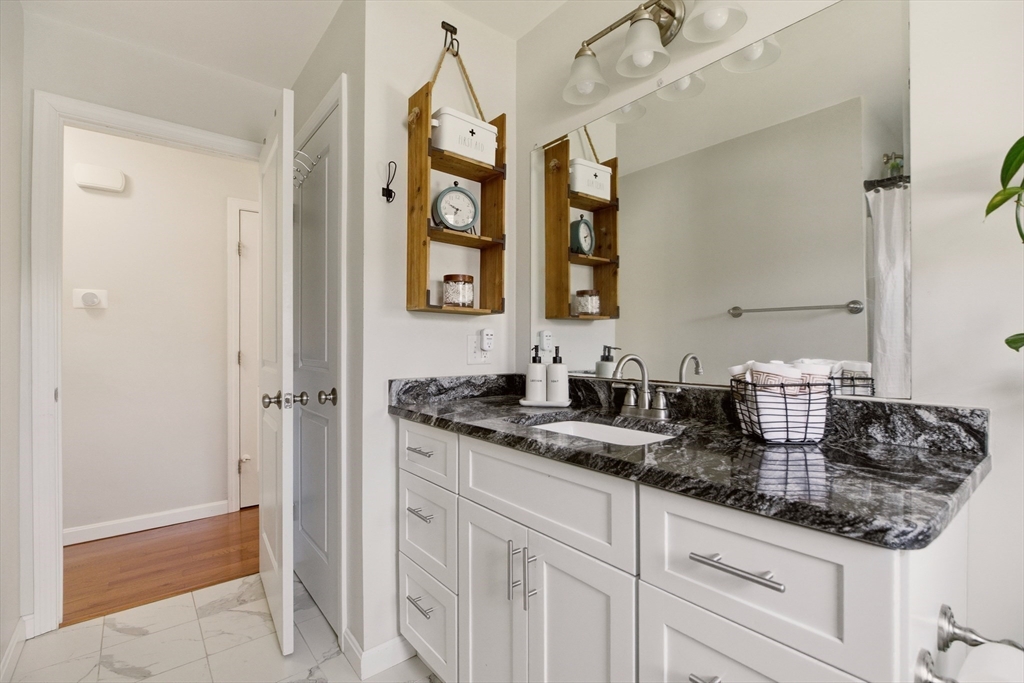 341 Courtney Street Fall River, MA 02720 - Photo 24 of 39 a bathroom with granite countertop a sink and a mirror