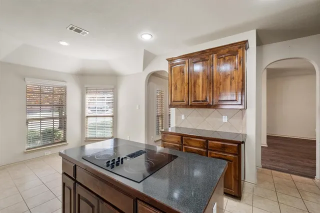 a large kitchen with stainless steel appliances lots of counter top space