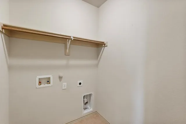 a backyard of a house with barbeque oven and wooden fence