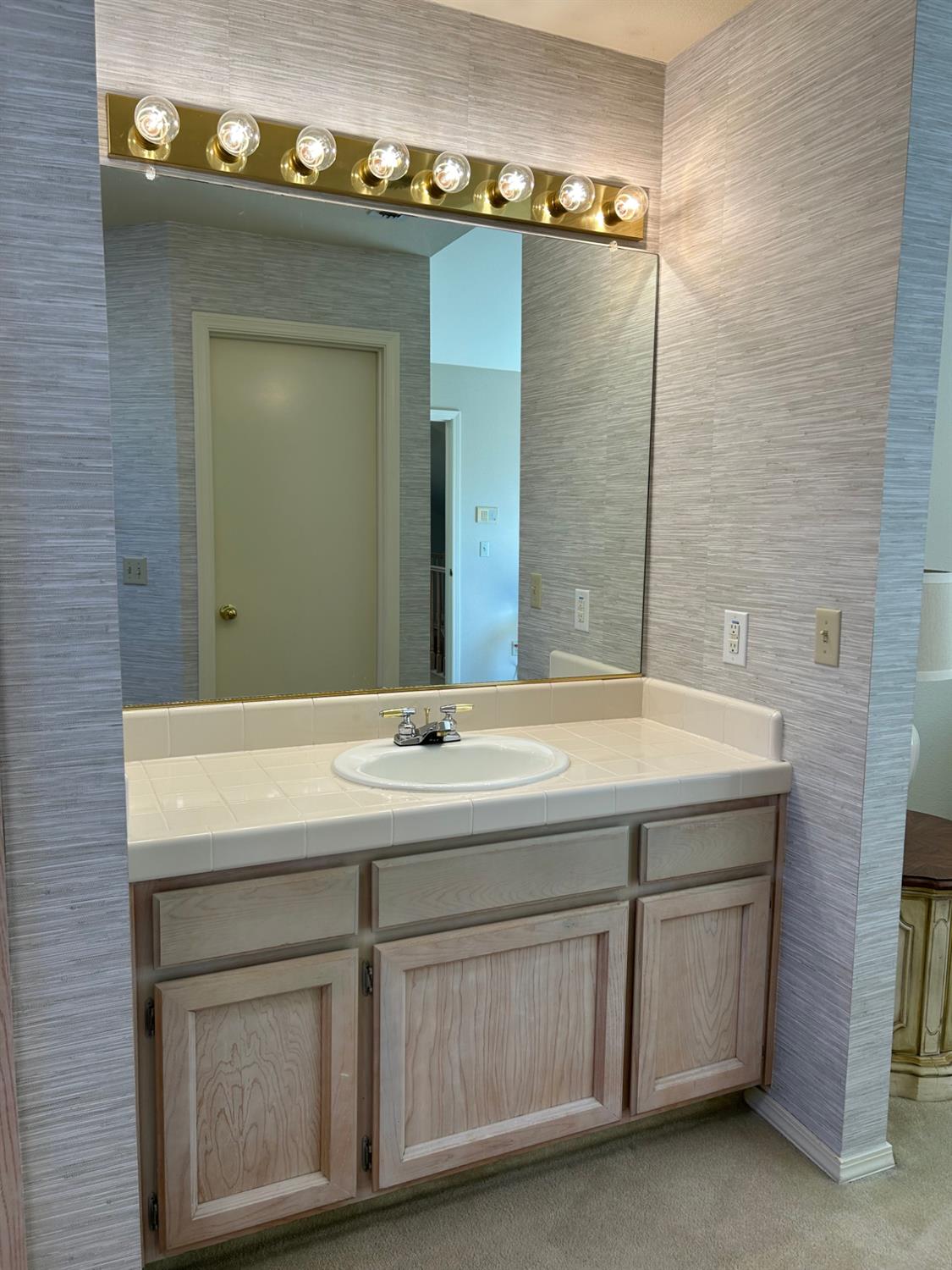 1067 Rio Cidade Way Sacramento, CA 95831 - Photo 27 of 33 a bathroom with a sink and a mirror