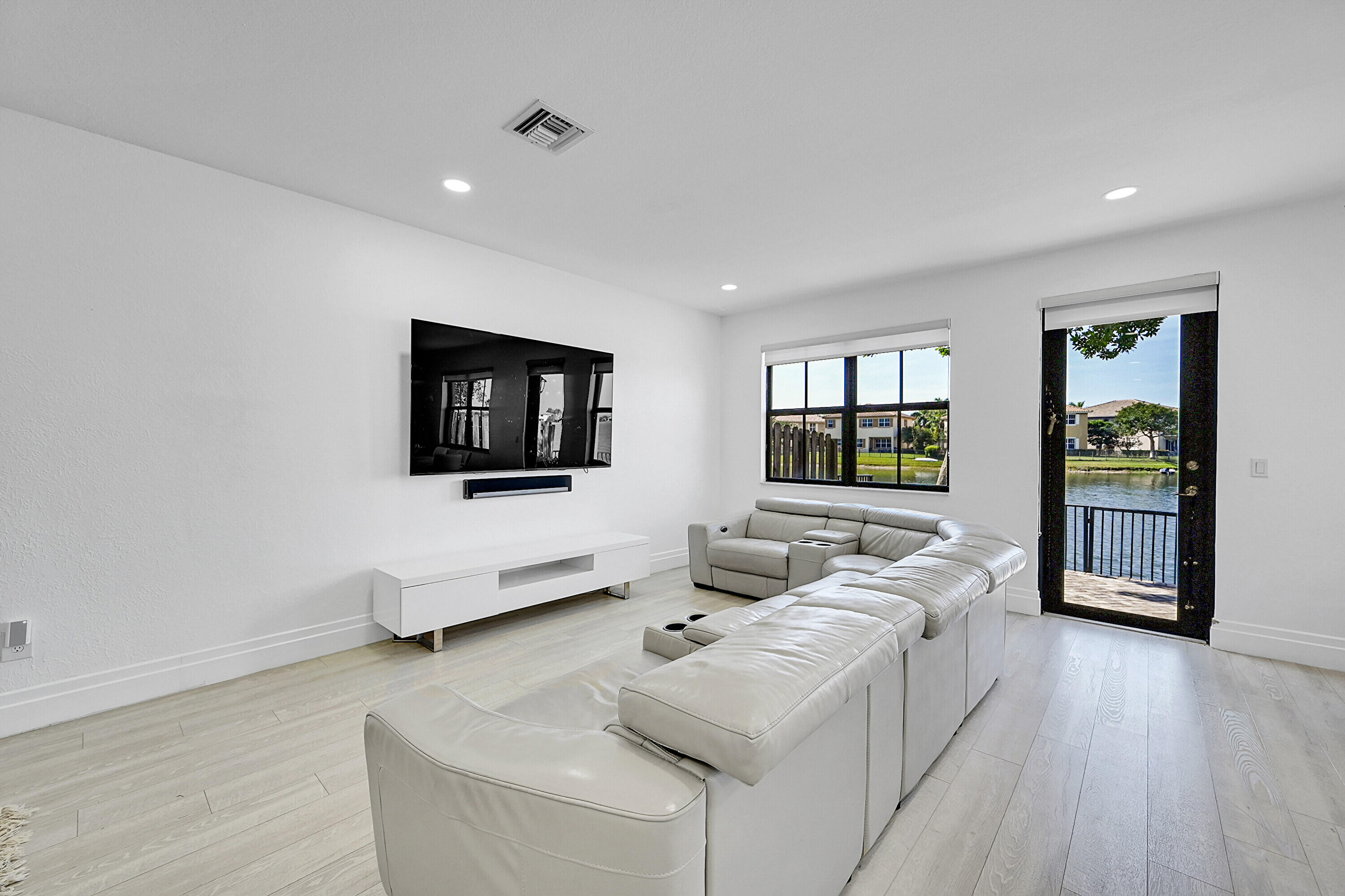 8459 Lakeview Trail Parkland, FL 33076 - Photo 11 of 55 a living room with furniture and a flat screen tv