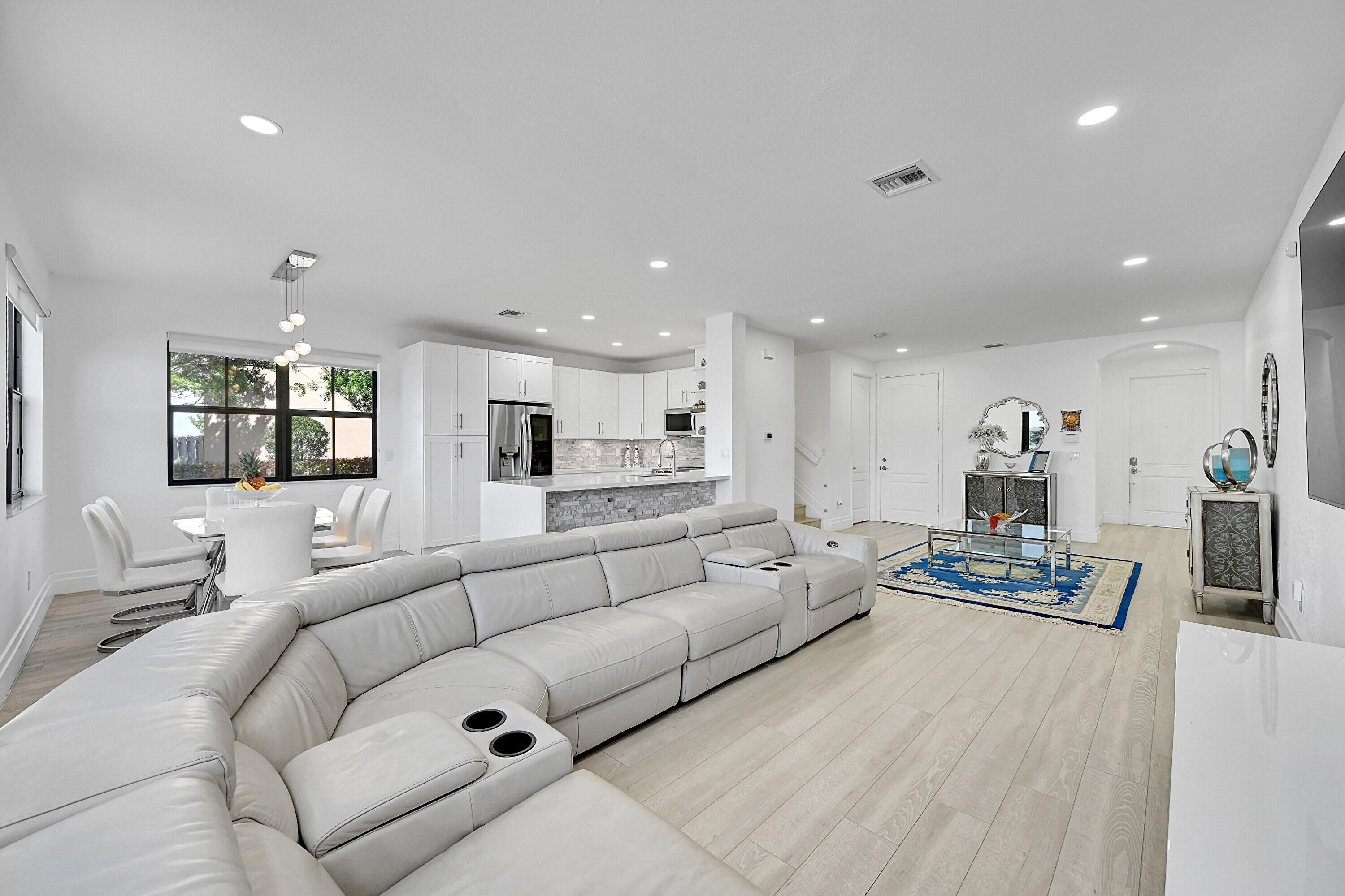 8459 Lakeview Trail Parkland, FL 33076 - Photo 12 of 55 a living room with furniture and a dining table with wooden floor