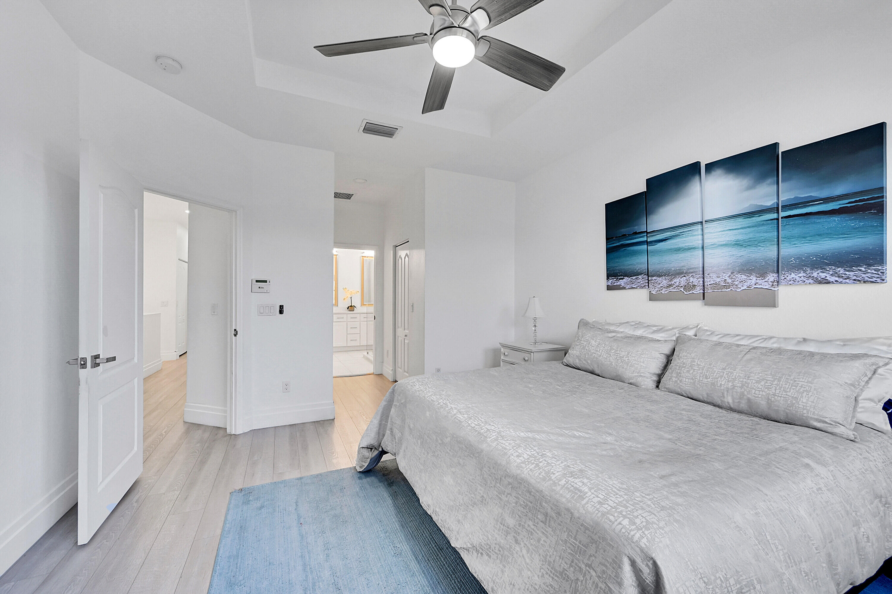 8459 Lakeview Trail Parkland, FL 33076 - Photo 23 of 55 a spacious bedroom with a bed and a chandelier