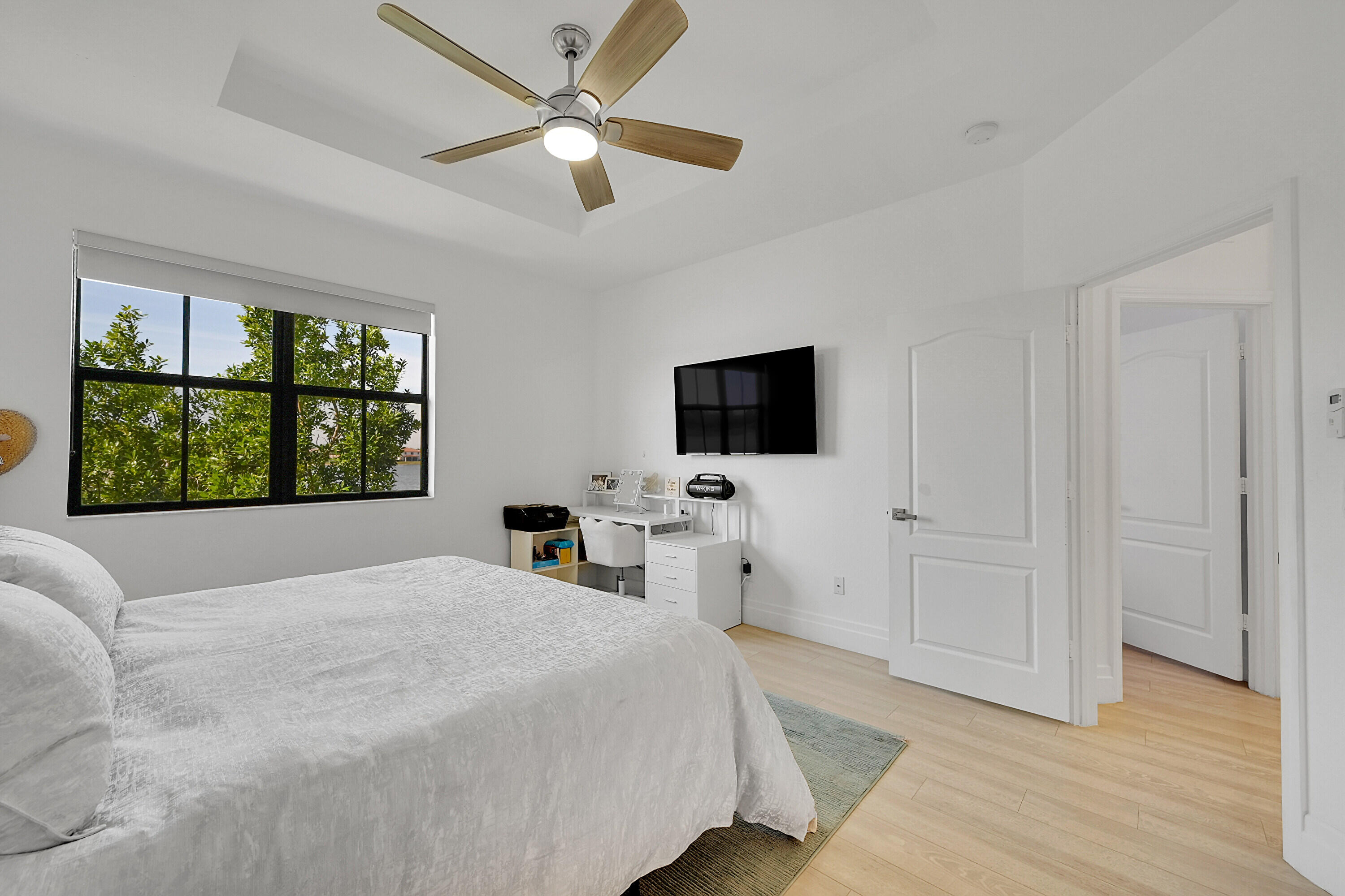 8459 Lakeview Trail Parkland, FL 33076 - Photo 24 of 55 a bedroom with a large bed and a flat tv screen on dresser