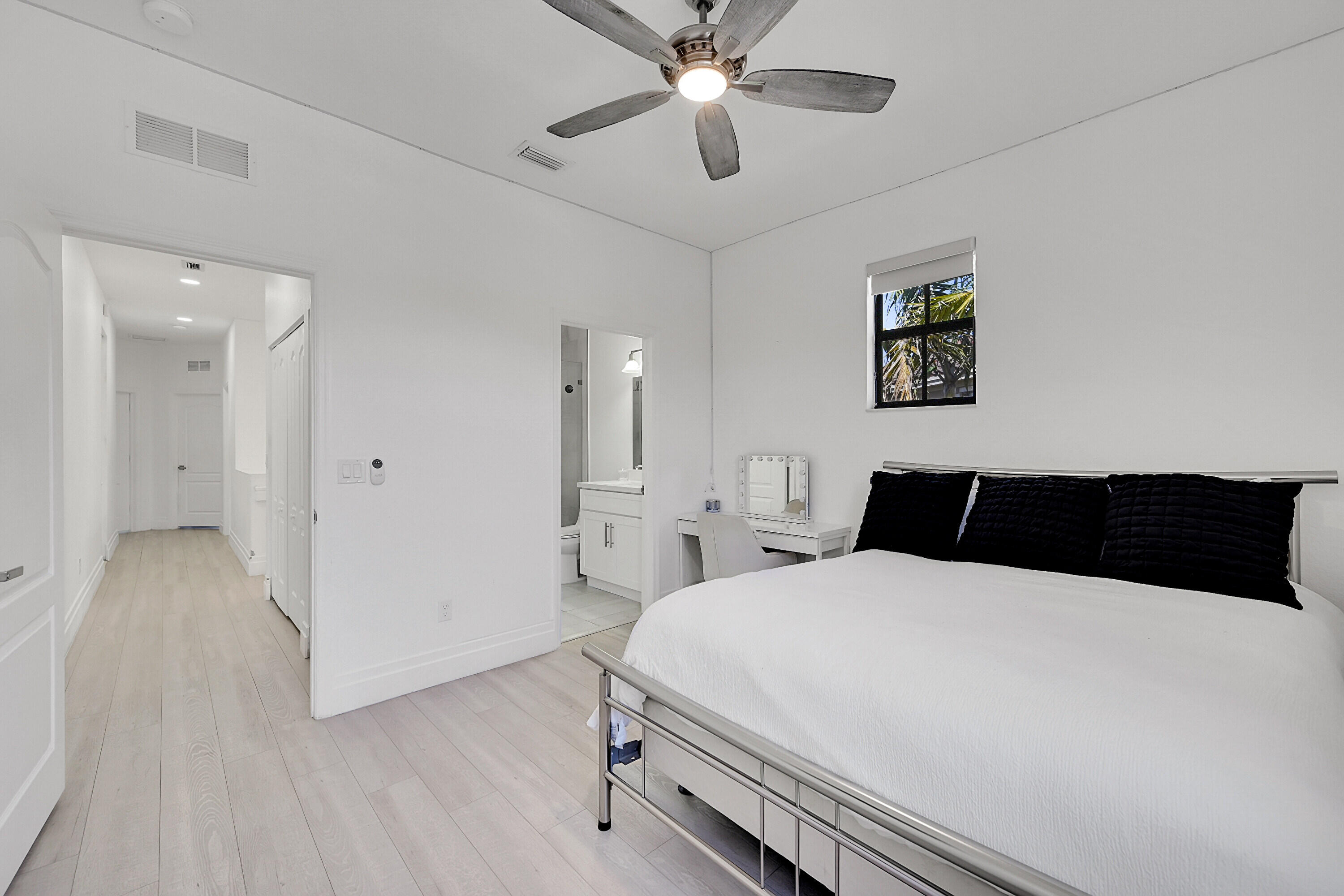 8459 Lakeview Trail Parkland, FL 33076 - Photo 28 of 55 a bedroom with a bed and a chandelier