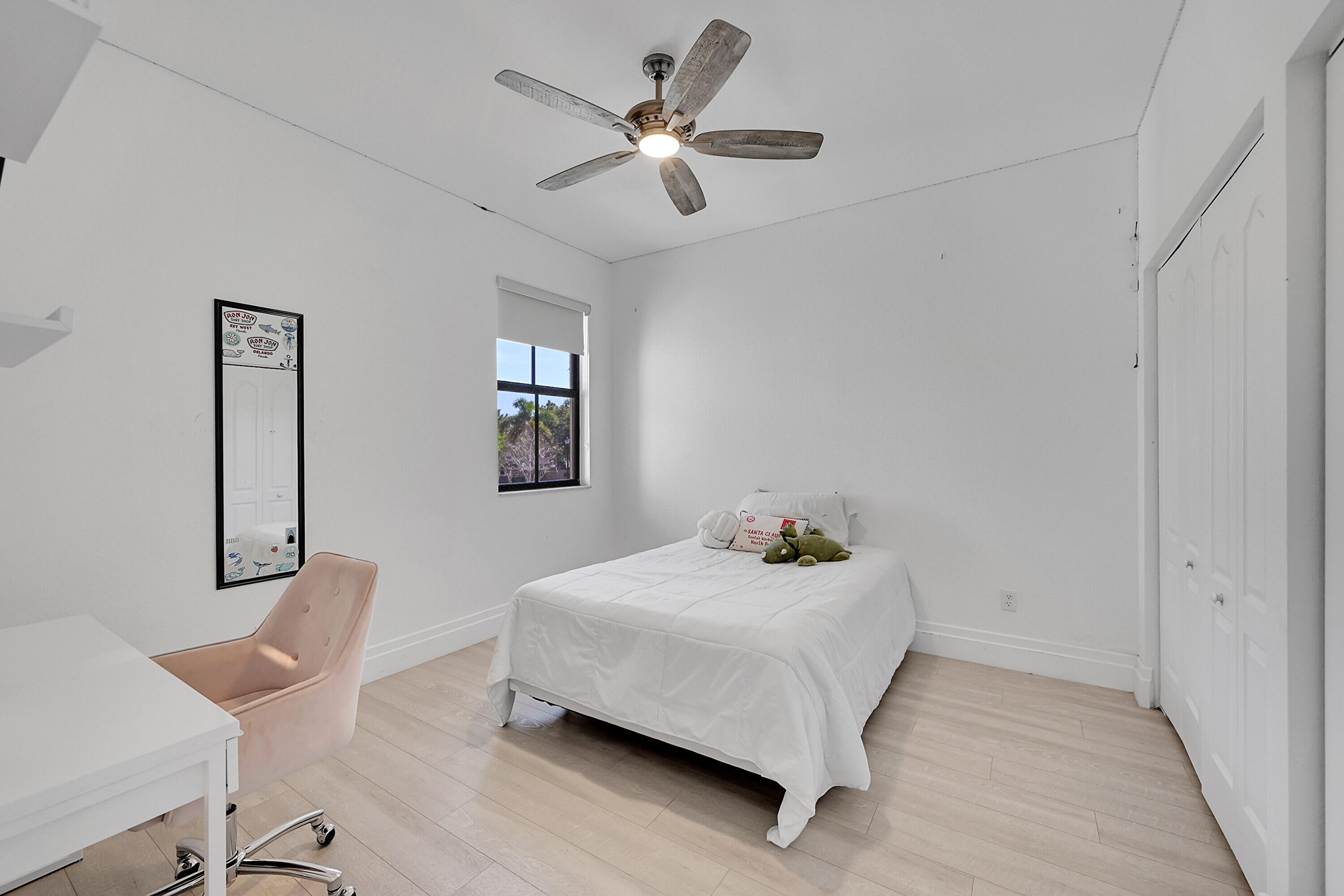 8459 Lakeview Trail Parkland, FL 33076 - Photo 30 of 55 a bedroom with a bed and a chandelier