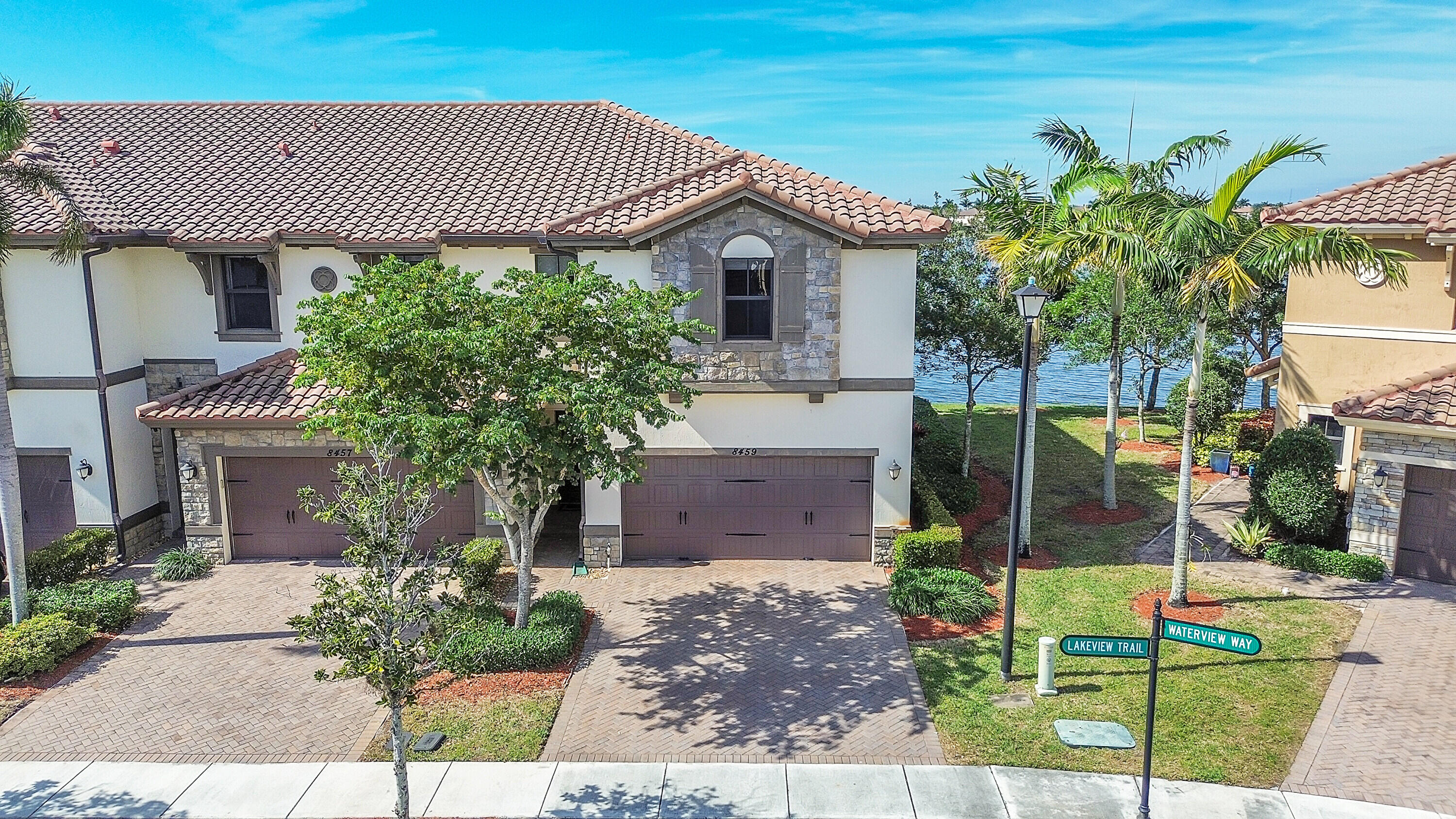 8459 Lakeview Trail Parkland, FL 33076 - Photo 40 of 55 a front view of a house with garden