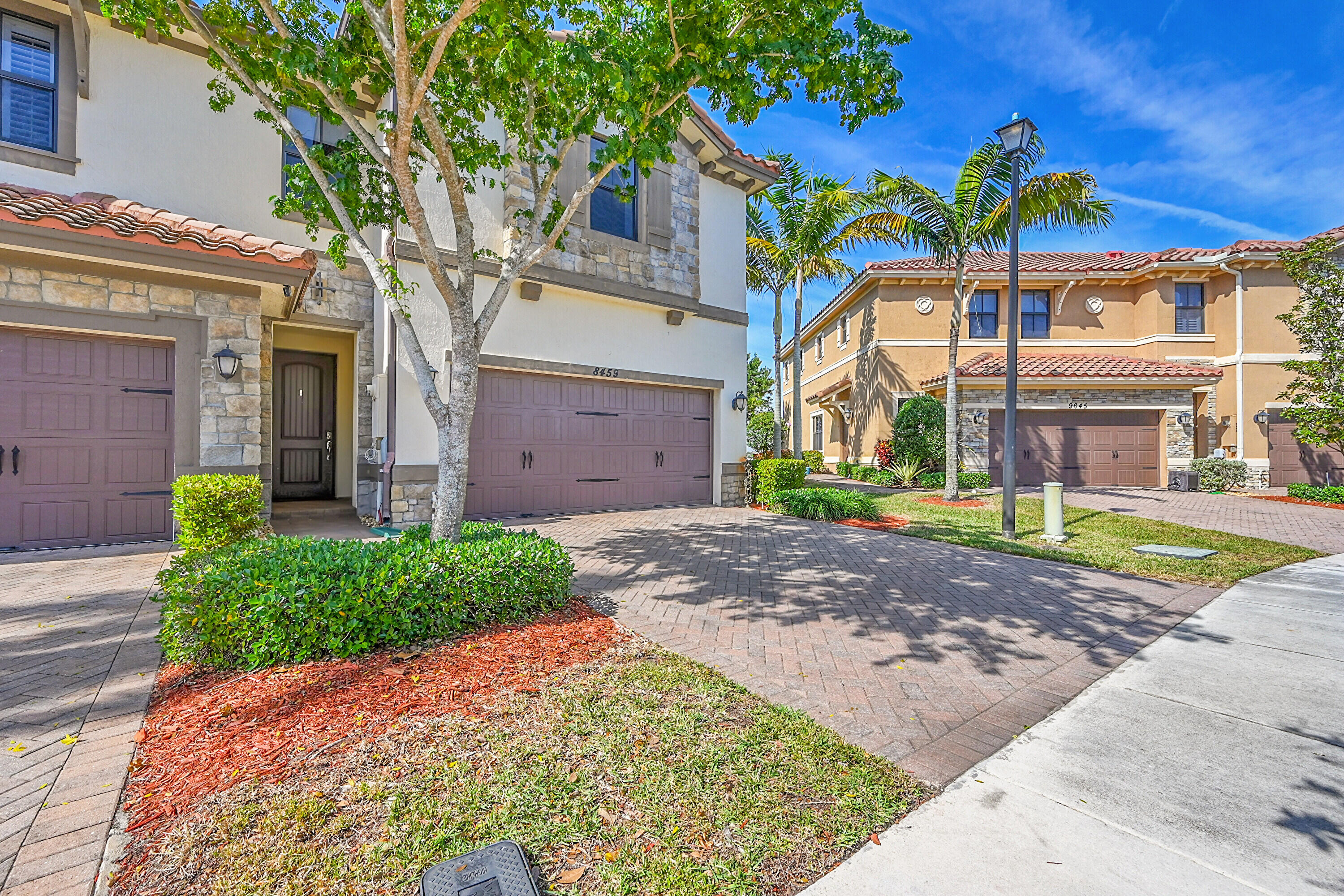 8459 Lakeview Trail Parkland, FL 33076 - Photo 4 of 55 a view of a house with a yard and potted plants