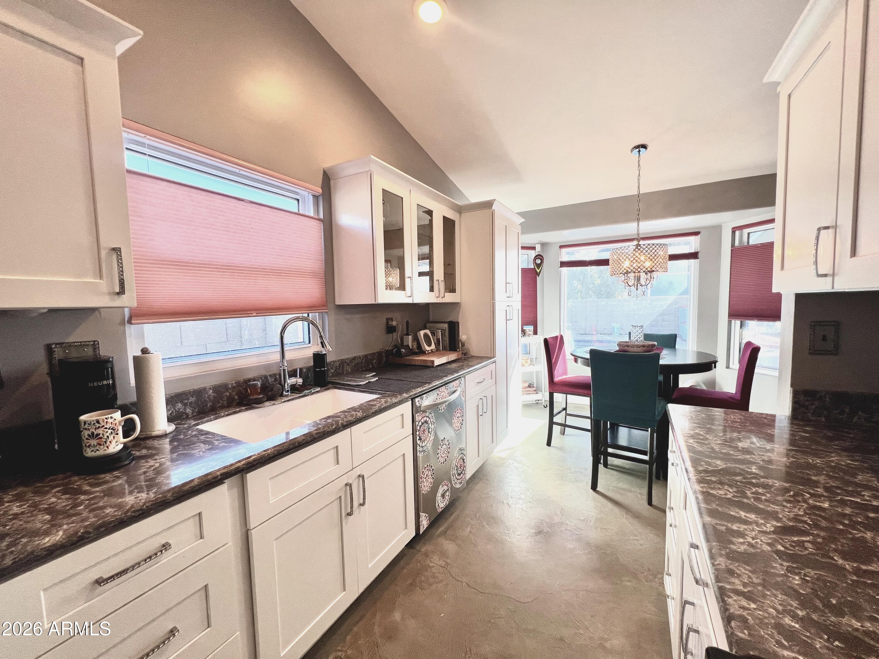 3425 East Libby Street Phoenix, AZ 85032 - Photo 7 of 16 a kitchen with granite countertop a sink stove and cabinets