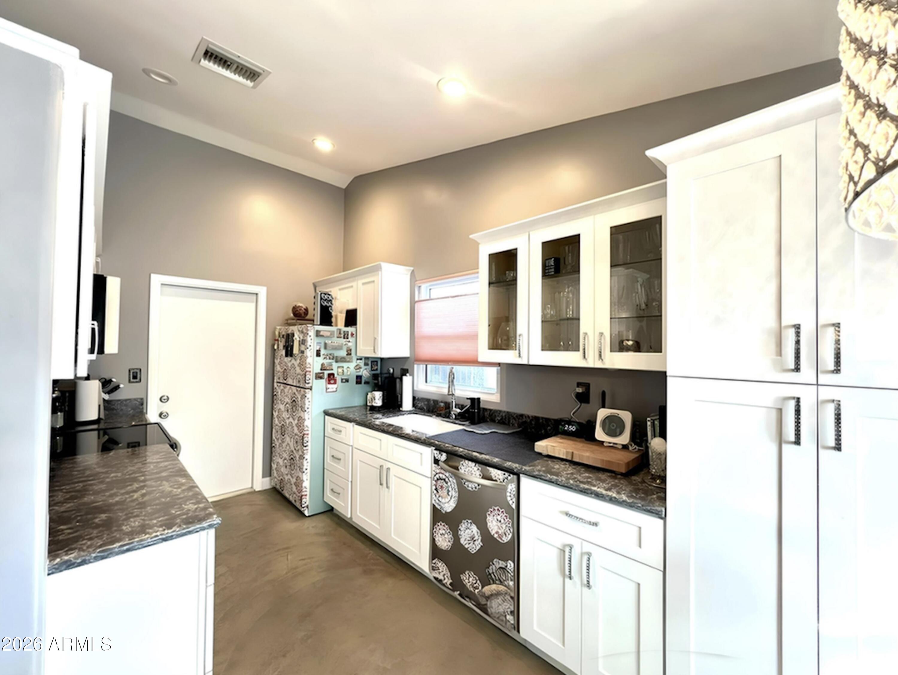 3425 East Libby Street Phoenix, AZ 85032 - Photo 8 of 16 a kitchen with a refrigerator and a sink