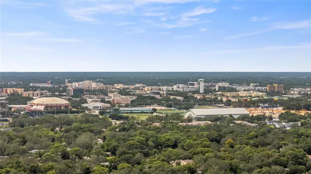 an aerial view of residential houses with outdoor space and trees