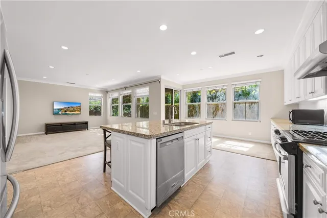 a kitchen with stainless steel appliances granite countertop a stove and a sink