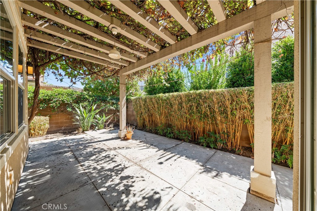 129 Overbrook Irvine, CA 92620 - Photo 19 of 41 a backyard of a house with large trees and a wooden fence