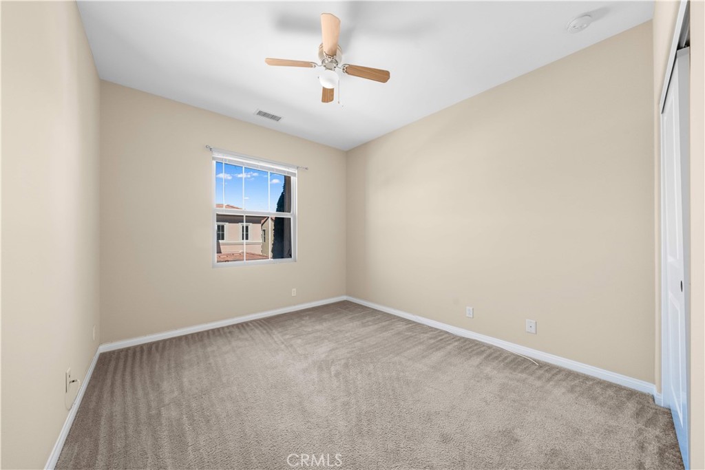 129 Overbrook Irvine, CA 92620 - Photo 34 of 41 an empty room with windows and ceiling fan
