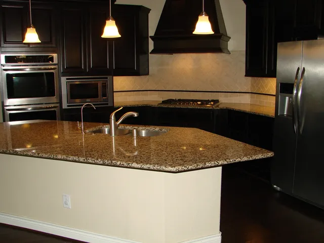 a kitchen with a refrigerator stove and cabinets