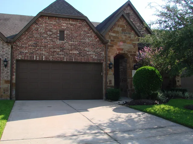 a view of a brick house with large windows