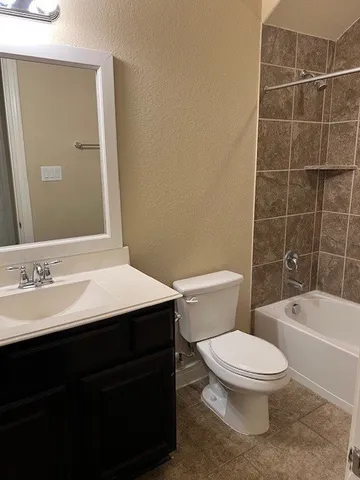 an empty room with closet and a bathroom