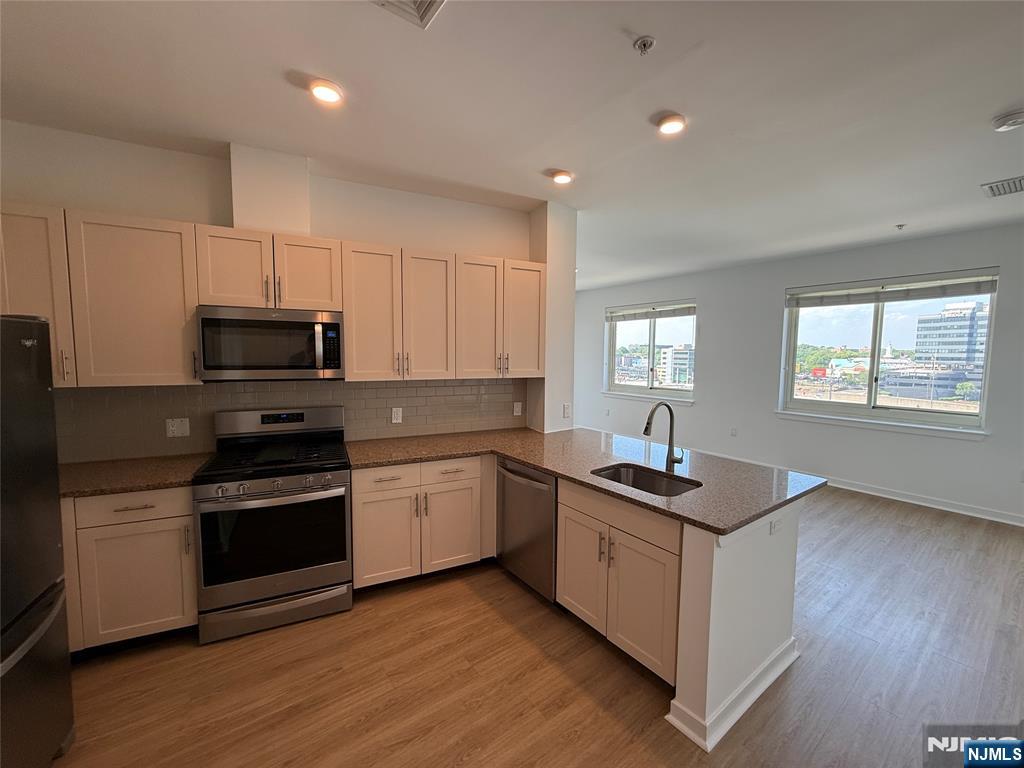 2050 North Central Road, Unit 710 Fort Lee, NJ 07024 - Photo 3 of 21 a kitchen with stainless steel appliances granite countertop a sink stove and refrigerator
