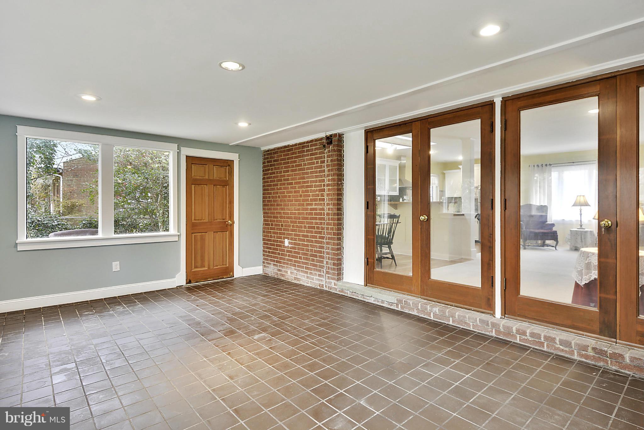 7405 Chatham Street Springfield, VA 22151 - Photo 14 of 30 a view of an empty room with wooden floor and a window