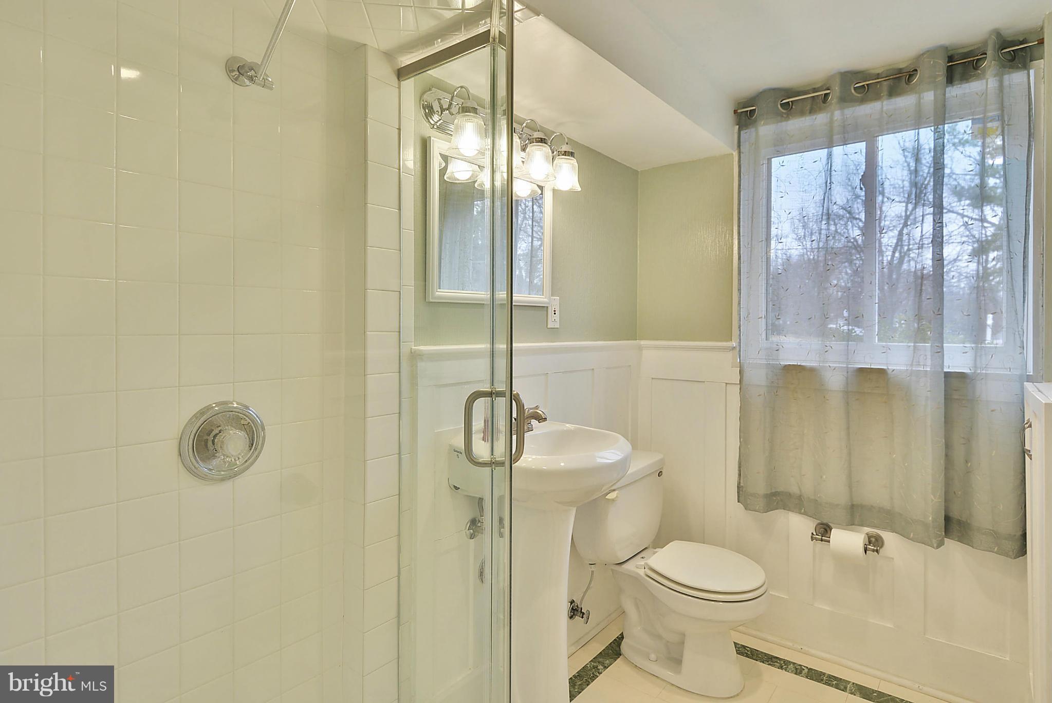 7405 Chatham Street Springfield, VA 22151 - Photo 15 of 30 a bathroom with a sink a toilet and shower
