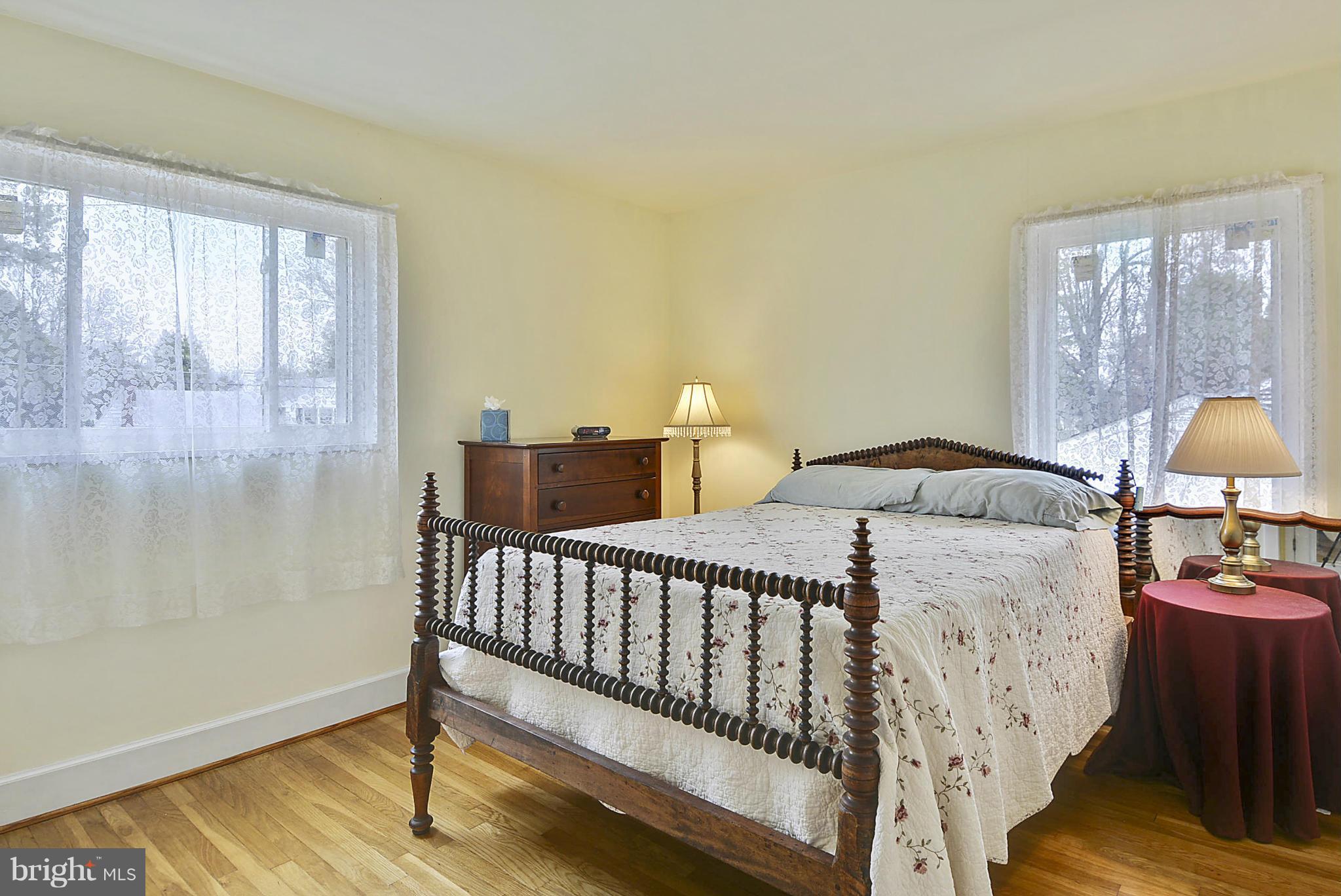 7405 Chatham Street Springfield, VA 22151 - Photo 21 of 30 a bedroom with a bed and wooden floor